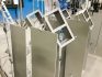 Powder coating line. Metal panels are suspended on an overhead conveyor line. Painting products in an electrostatic field.